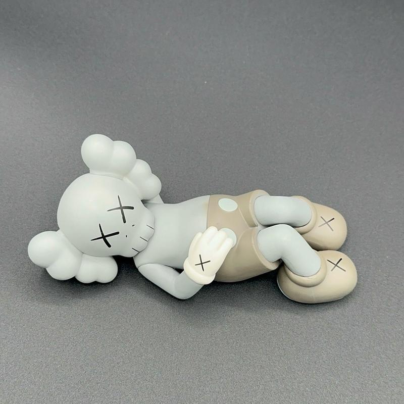 Laying down KAWS mini figure