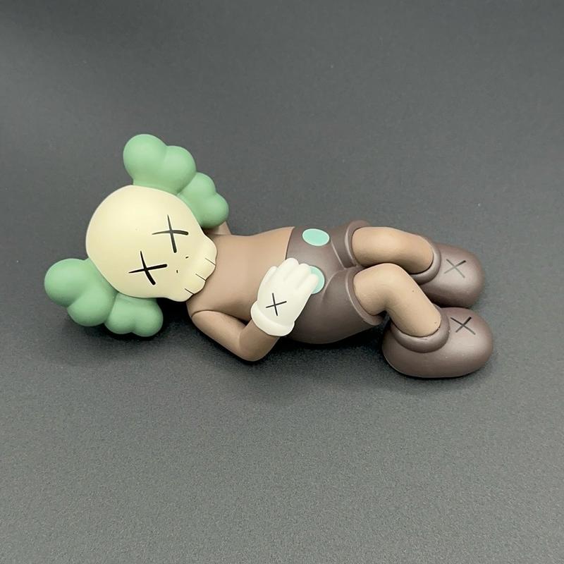 Laying down KAWS mini figure