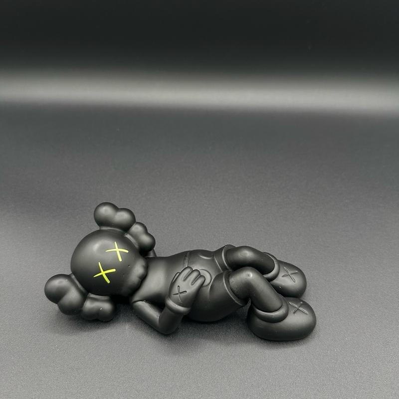 Laying down KAWS mini figure